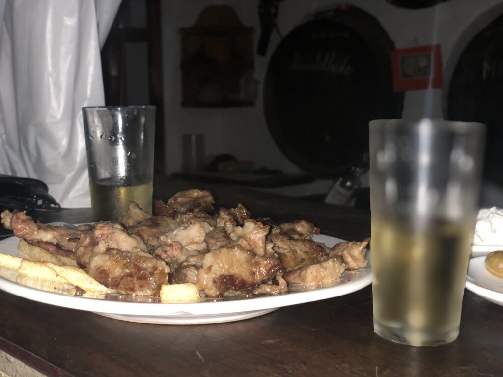Cachitos, que es como denominan aquí al lagartito de cerdo con dos vasos de vino en La Herrería en el Barrio Alto de Sanlúcar de Barrameda